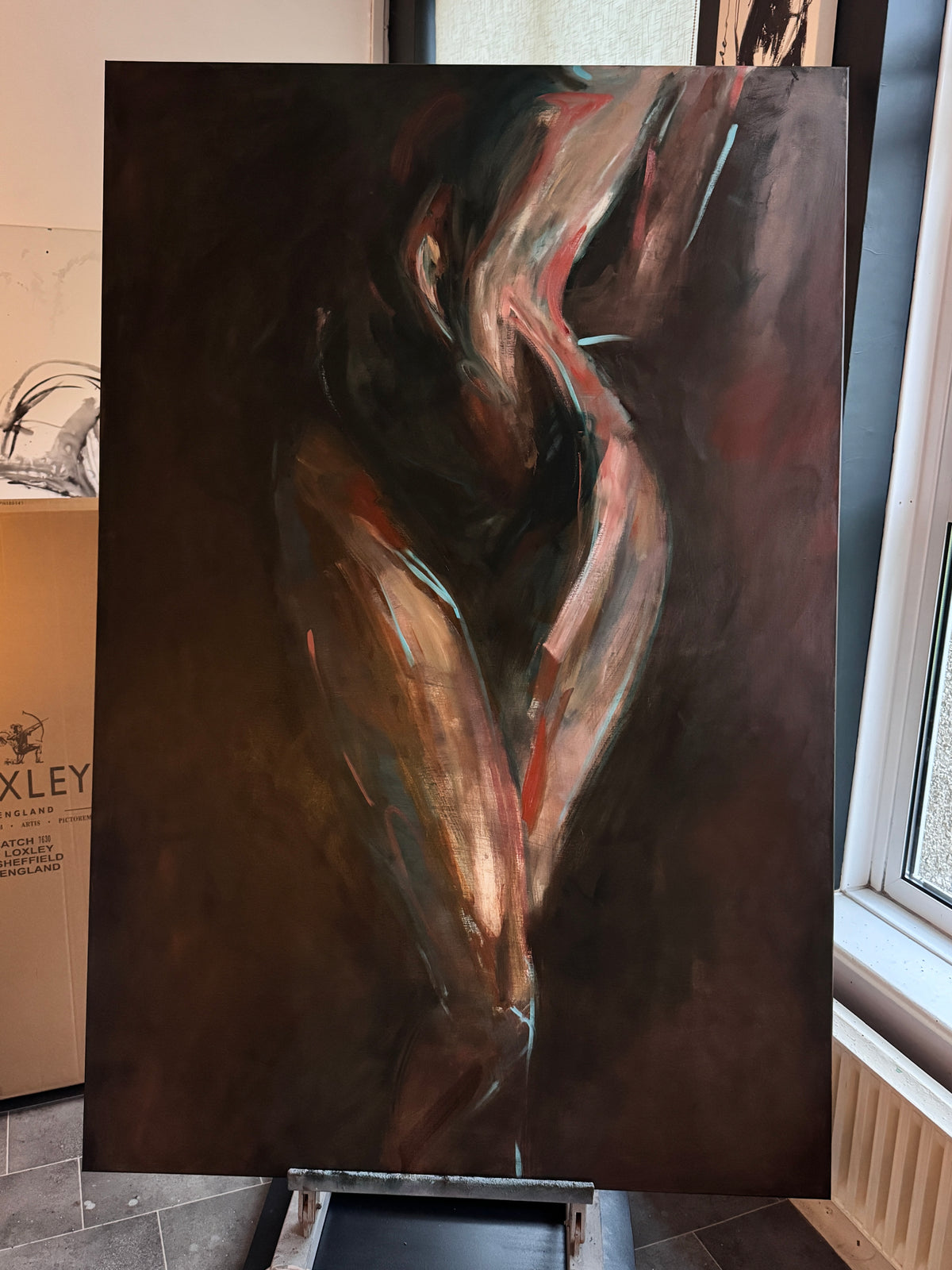Roberta Heslop in studio with original painting Awakening - behind the scenes female form art