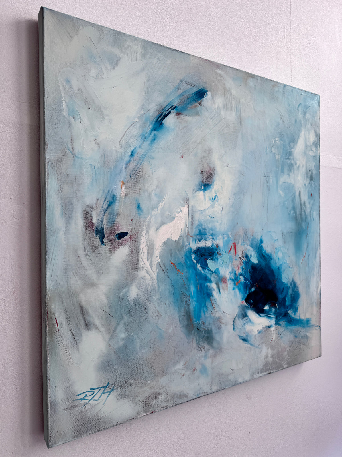 Side view of Fire and Ice abstract painting showing deep edge canvas profile, 30x30 oil painting by Roberta Heslop in studio